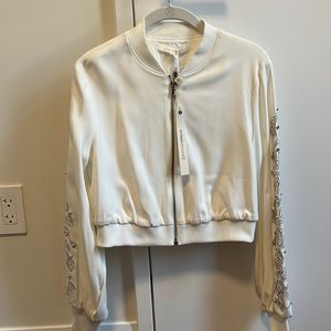 Jonathan Simkhai white bomber jacket with embellishments on arm